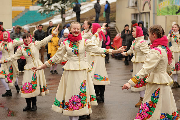 Orel, Russia - March 13, 2016: Maslenitsa, Pancake festival. Girls in white slavonic clothes dancing outdoors closeup